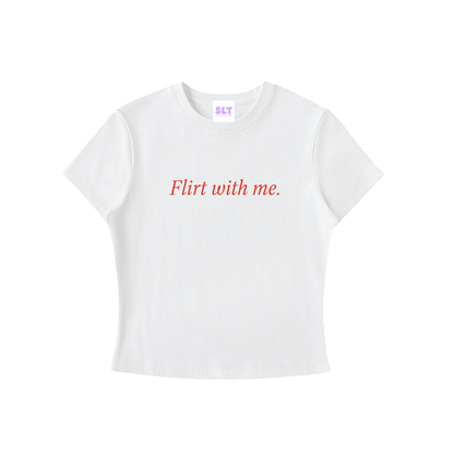 A white short-sleeve crop top t-shirt with the phrase 'Flirt with me.' printed in red cursive across the chest.