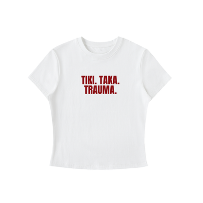 White t-shirt with red text 'TIKI. TAKA. TRAUMA.' on a white background
