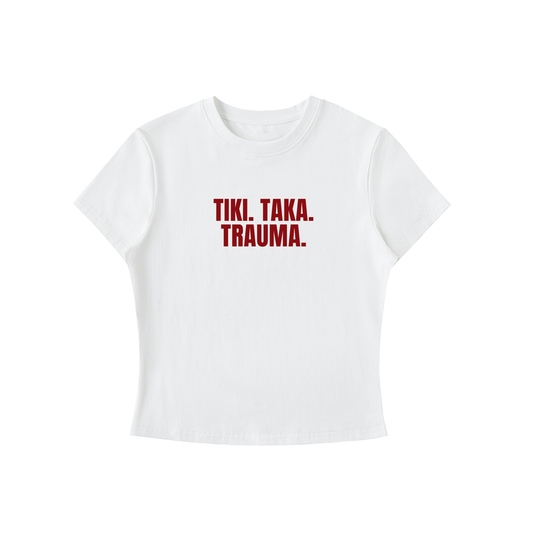 White t-shirt with red text 'TIKI. TAKA. TRAUMA.' on a white background