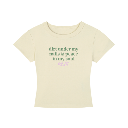 Beige t-shirt with green text 'dirt under my nails & peace in my soul' on a white background